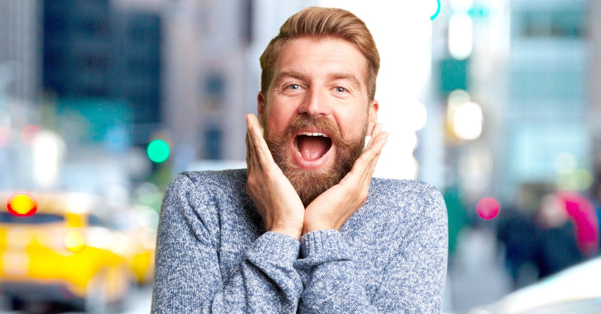 A man expressing surprise and excitement, a perfect reaction to a funny animal joke.