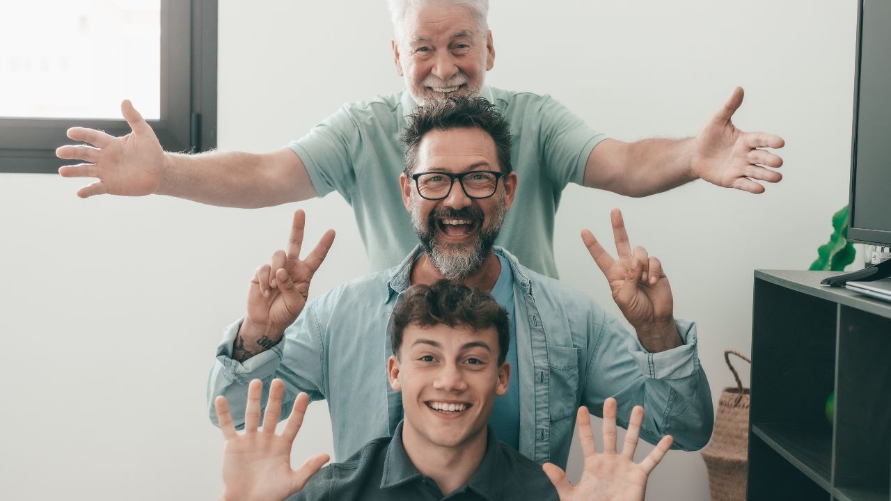 A family of three generations, with grandpa, dad, and son, sharing a lighthearted moment together, making funny poses. Family-Friendly Dad Jokes That Bring Everyone Together