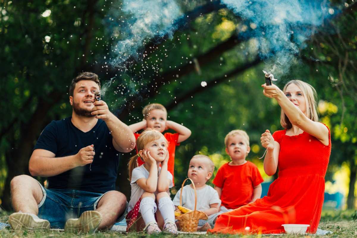 A joyful family laughing outdoors, sharing hilarious jokes and creating happy memories together