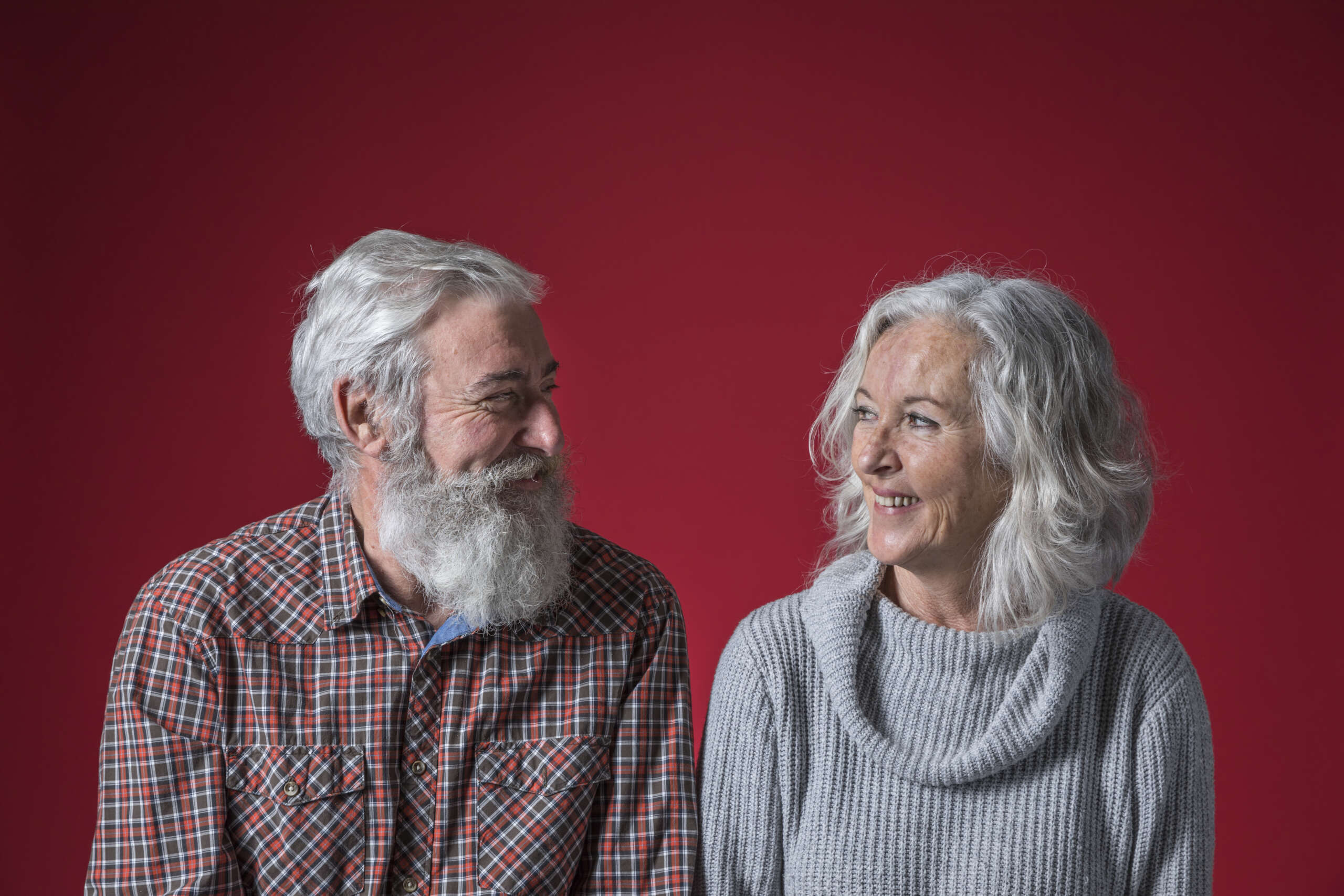 Happy senior couple laughing together after hearing the best funny jokes