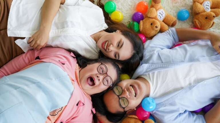 Family enjoying playful moments together, surrounded by colorful balls and stuffed bears, sharing laughter and joy. Family-Friendly Knock-Knock Jokes: