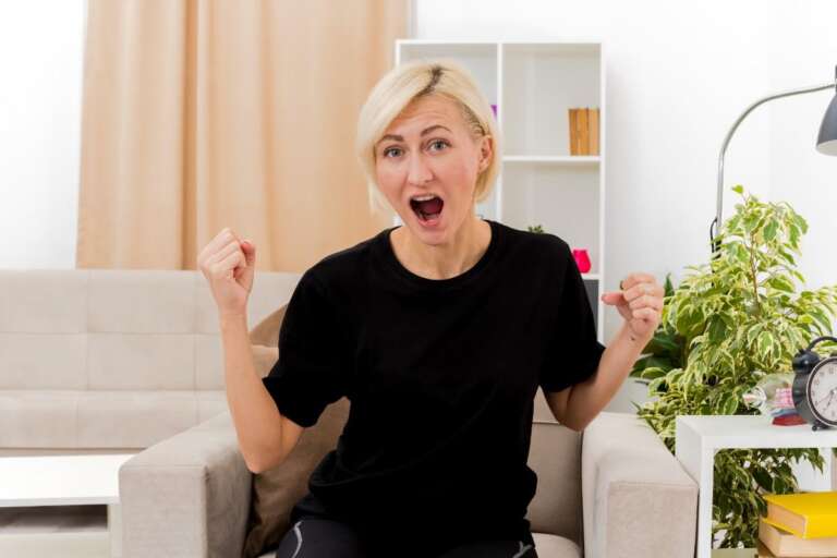 Woman laughing and cheering after hearing a funny joke,Yo Mama Jokes So Funny They’ll Leave You Rolling