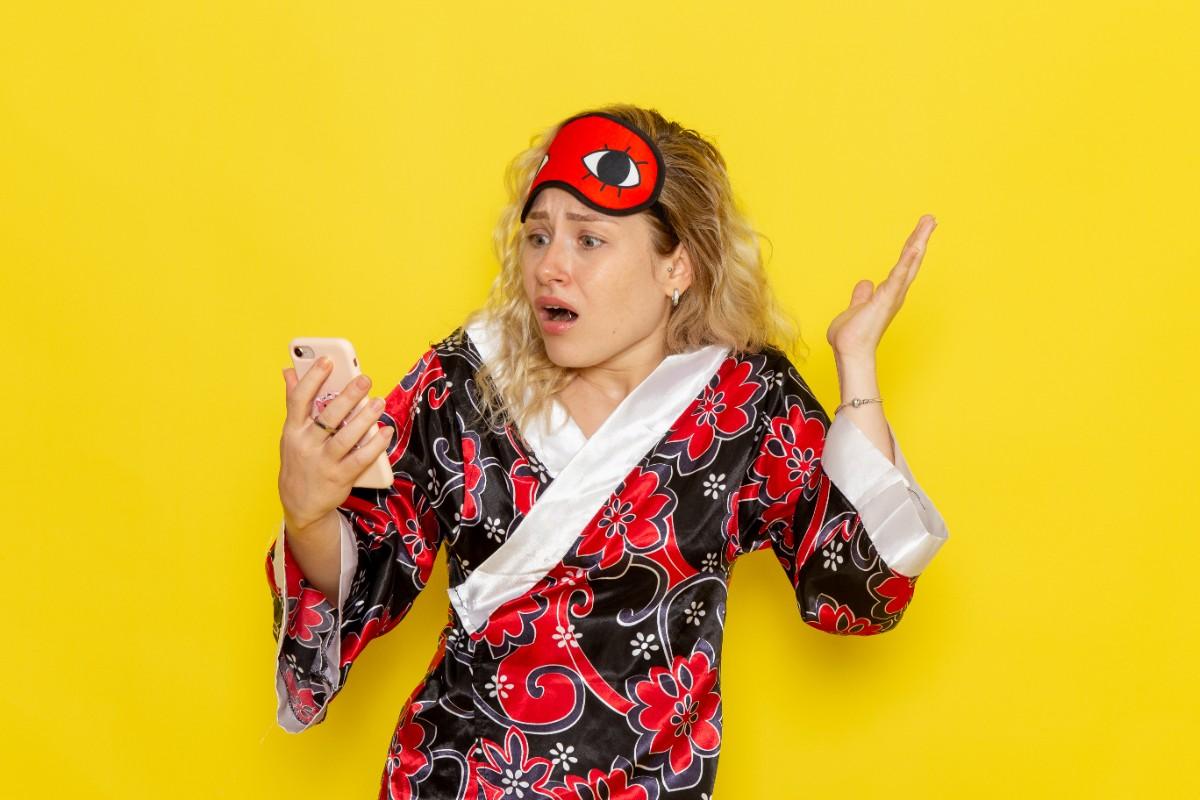 Woman shocked while reading something funny on her phone
